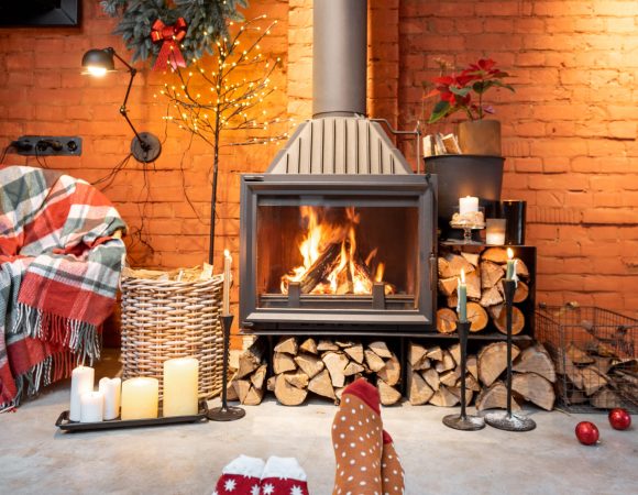 Couple in Christmas socks by the fireplace at home. The concept of comfort during winter and New Year holidays